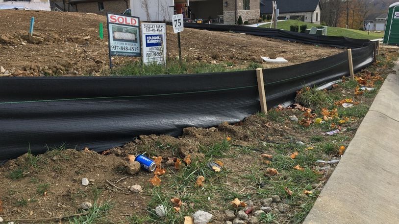 Black skirting is installed to prevent runoff at construction sites in the Highview Terrace residential development by Clemens Companies in Bellbrook. RICHARD WILSON/STAFF