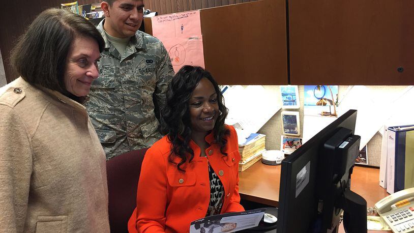 Susy Himelhoch (left), Ohio Combined Federal Campaign, Miami Valley District, volunteer executive director; Airman 1st Class Jeremy Tobar, CFC campaign loaned executive; and Chantaé Gray, loaned executive, review the new CFC pledge site Nov. 13. (Skywrighter photo/Amy Rollins)