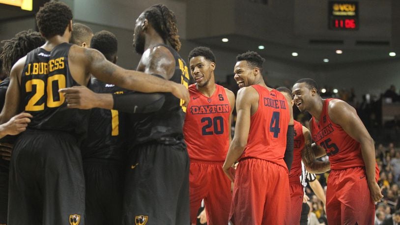 Dayton's Xeyrius Williams, Charles Cooke and Kendall Pollard share a laugh during a game against Virginia Commonwealth on Jan. 27, 2017, at the Siegel Center in Richmond, Va.