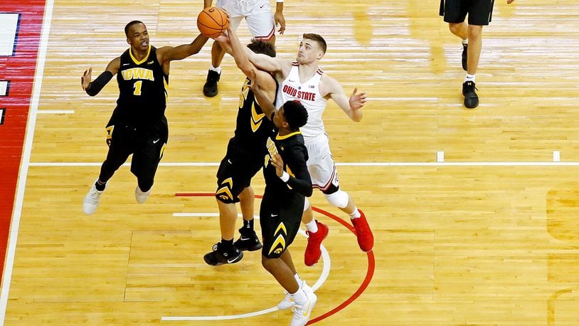COLUMBUS, OH - FEBRUARY 10:  Maishe Dailey #1 of the Iowa Hawkeyes and Micah Potter #0 of the Ohio State Buckeyes compete for a rebound during the game at Value City Arena on February 10, 2018 in Columbus, Ohio. Ohio State defeated Iowa 82-64. (Photo by Kirk Irwin/Getty Images)