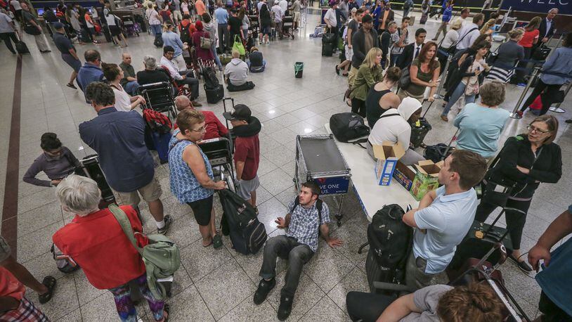 Stranded Delta passengers in 2016 at Hartsfield-Jackson International Airport in Atlanta, Ga. United Airlines is testing informing passengers why their flights are delayed. (John Spink/Atlanta Journal-Constitution/TNS)