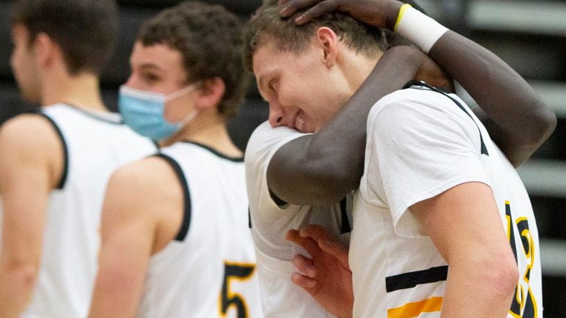 Centerville's Rich Rolf gets a hug from teammate Emmanuel Deng after Rolf made four 3-pointers in the fourth quarter Friday night to spark the Elks to a 71-65 victory over visiting Wayne. Rolf scored 25 points. Jeff Gilbert/CONTRIBUTED