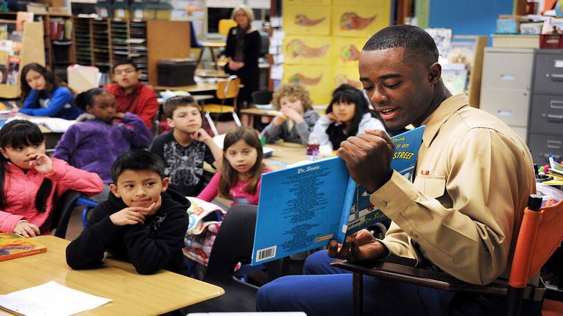 PRESIDIO OF MONTEREY, Calif. - Defense Language Institute Foreign Language Center student Pvt. Michael Odoms, Marine Corps Detachment Monterey, reads from the book And to Think That I Saw It on Mulberry Street by Dr. Seuss to children at Foothill Elementary on March 1 in celebration of the 108th birthday of the famous children’s author and artist. (Flickr/Presidio of Monterey)
