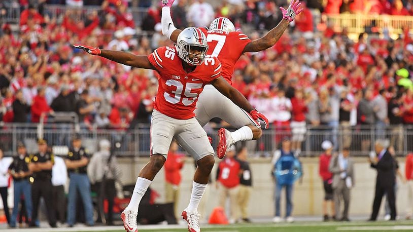COLUMBUS, OH - OCTOBER 8: Chris Worley #35 of the Ohio State Buckeyes and Damon Webb #7 of the Ohio State Buckeyes celebrate after stopping the Indiana Hoosiers on fourth down near the goal line in the fourth quarter at Ohio Stadium on October 8, 2016 in Columbus, Ohio. Ohio State defeated Indiana 38-17. (Photo by Jamie Sabau/Getty Images)