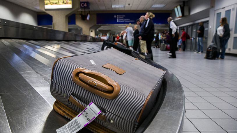 Luggage circles a baggage claim at Gate C on March 10, 2017, at DFW International Airport in Dallas. (Ashley Landis/Dallas Morning News/TNS)