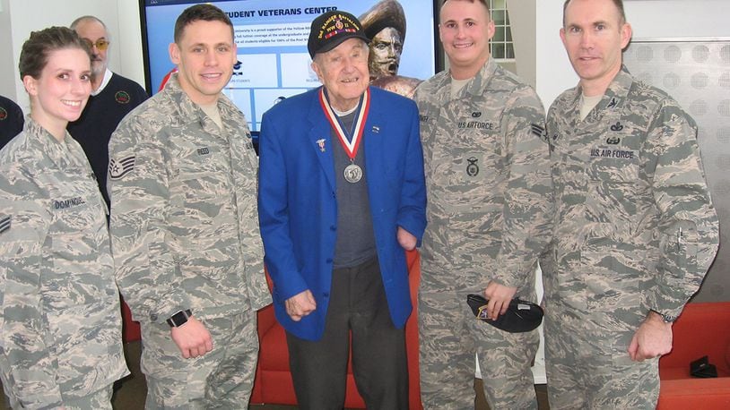 Col. Leonard Rose, 88th Mission Support Group commander, along with Staff Sgt. Michael Reed, Senior Airman Scott Dymacek and Senior Airman Joice Dominguez meet with World War II veteran Thomas Anderson at the Xavier University Student Veterans Center Feb 3. (U.S. Air Force photo/Mark C. Lyle)
