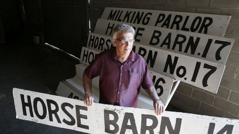 Greg Wallace, executive director for the Montgomery County Agricultural Society, holds one of the signs that designated the horse barns at the Montgomery County Fairgrounds. The signs, along with other nostalgic items, and a variety of office chairs, a fork lift, a tractor and more will be auctioned off Tuesday, Sept. 26 at noon at the fairgrounds. LISA POWELL / STAFF