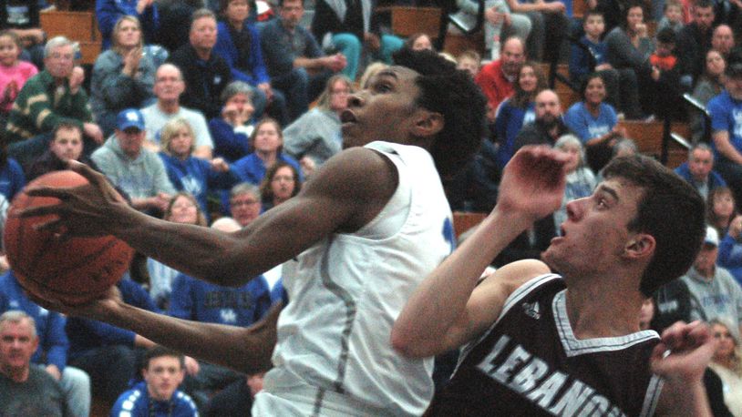 Miamisburg’s Savon O’Neal takes the ball to the basket as Zach Huffman applies pressure for Lebanon. Miamisburg wrapped up the Greater Western Ohio Conference National West Division title with a 41-29 win Friday night at home. JOHN CUMMINGS / CONTRIBUTED