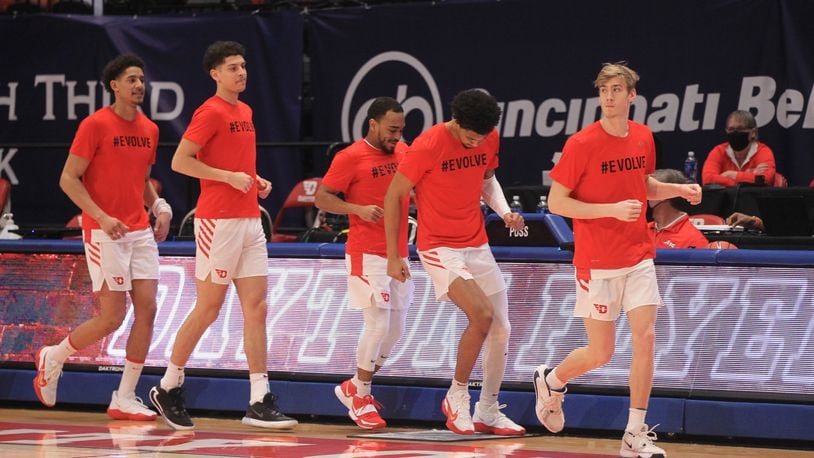 Dayton players, including Luke Frazier, right, take the court before a game against Virginia Commonwealth on Tuesday, Feb. 9, 2021, at UD Arena in Dayton. David Jablonski/