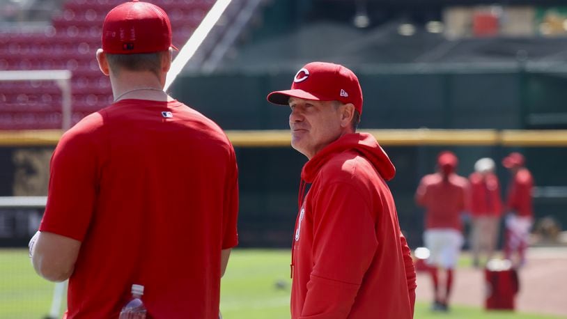 Reds manager David Bell, right, talks to Tyler Stephenson during batting practice on Opening Day on Thursday, March 30, 2023, at Great American Ball Park in Cincinnati. David Jablonski/Staff