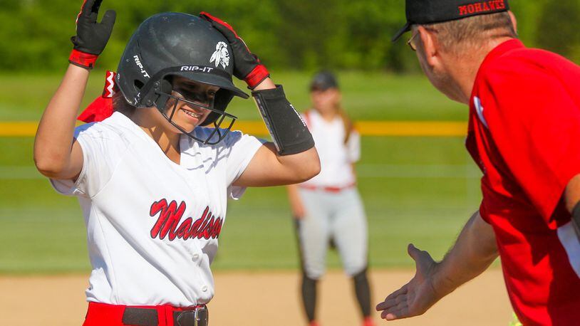 Madison’s Kenzi Saunders (19) is congratulated by coach Doug Pemberton after hitting a triple during a Division III sectional final against Carlisle at Fenwick on May 15, 2017. The Mohawks won 3-1, giving Pemberton what turned out to be the final victory of his prep coaching career. He died of a heart attack just over a month later. GREG LYNCH/STAFF