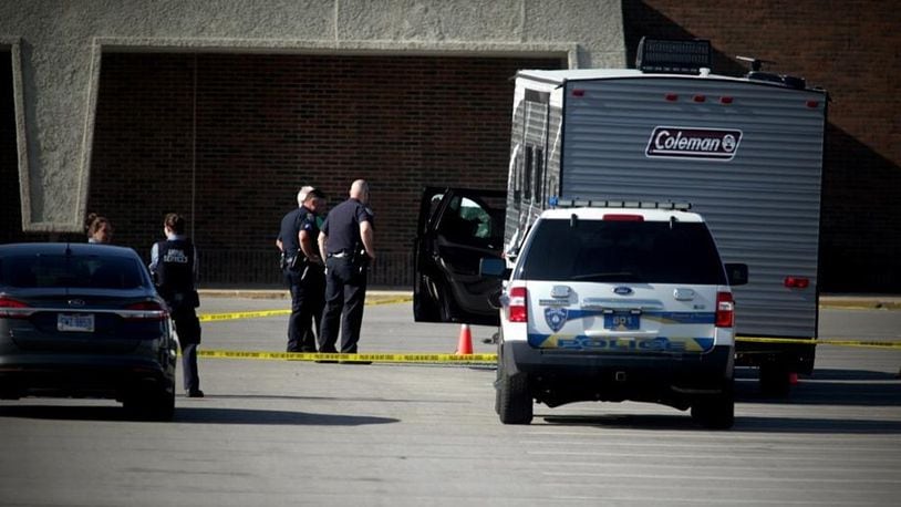 Police investigate the scene of a shooting outside the Dayton Mall Sears on Monday.