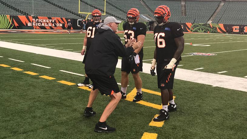 Bengals offensive line coach Frank Pollack goes over technique with several players during Saturday’s practice at Paul Brown Stadium. DDN FILE