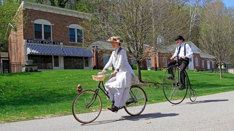 Staff, dressed for the era, ride bikes at Carillon Historical Park. SKIP PETERSON/CONTRIBUTED