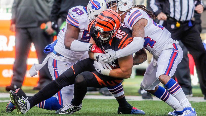 Cincinnati Bengals tight end Tyler Eifert is tackled by Buffalo Bills linebacker Zach Brown (53) and cornerback Stephon Gilmore (24) during their 16-12 loss to the Buffalo Bills Sunday, Nov. 20 at Paul Brown Stadium in Cincinnati. Woods was injured on the play. NICK GRAHAM/STAFF