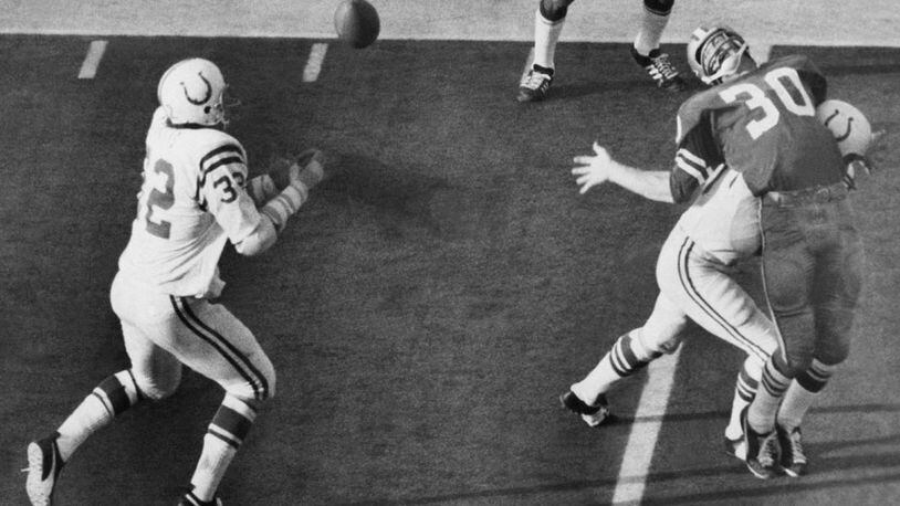 Mike Curtis (32) makes a key interception in Super Bowl V after Dan Reeves (30) was hit by Jerry Logan. The pick enabled the Colts to win the game, 16-13, against Dallas.