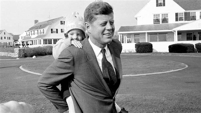 Caroline Kennedy gets a piggy-back ride from her father in this Nov. 9, 1960, file photo.