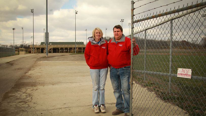Steve Rauch of Steve R. Rauch Inc. and former employee Jennifer Copeland stand at the front gate of the recreational facility that Rauch and business partner Sam Morgan donated to the city of Moraine.
