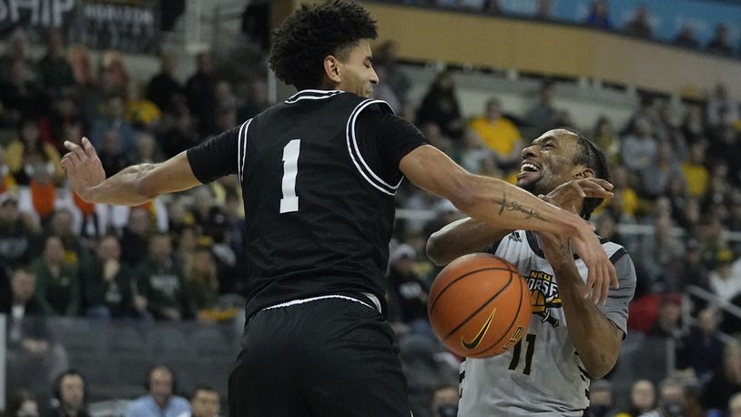 Northern Kentucky's Bryson Langdon (11) has the basketball stripped by Wright State's Trey Calvin (1) during the first half of an NCAA college basketball game for the Horizon League men's tournament championship Tuesday, March 8, 2022, in Indianapolis. (AP Photo/Darron Cummings)