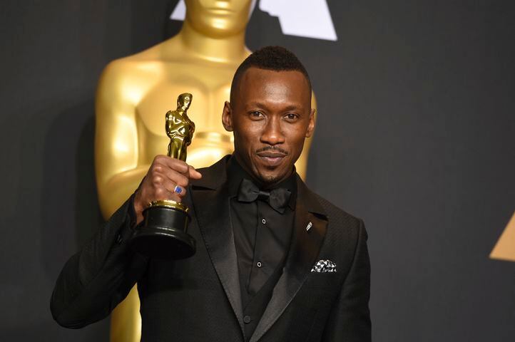 Mahershala Ali poses in the press room with the award for best actor in a supporting role