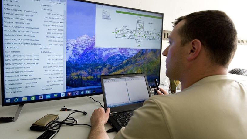 Former U.S. Air Force Capt. Chris Perrine, Air Force Life Cycle Management Center, chief of acquisitions for net centric services-2, from Robins Air Force Base, Ga., monitors his team’s active shooter detection system during the 2015 Air Force Research Laboratory Commander’s Challenge. The system, which was patented by the Air Force, enables dispatchers to see exactly where in the building an alarm was activated and inform emergency responders, allowing them to better respond to the threat. Protective Innovations LLC, a company started by Perrine after his separation, licensed the technology for commercialization in 2017. (U.S. Air Force photo/Wesley Farnsworth)