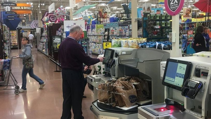 A customer uses self checkout at a Kroger store in the Dayton region. KARA DRISCOLL/STAFF
