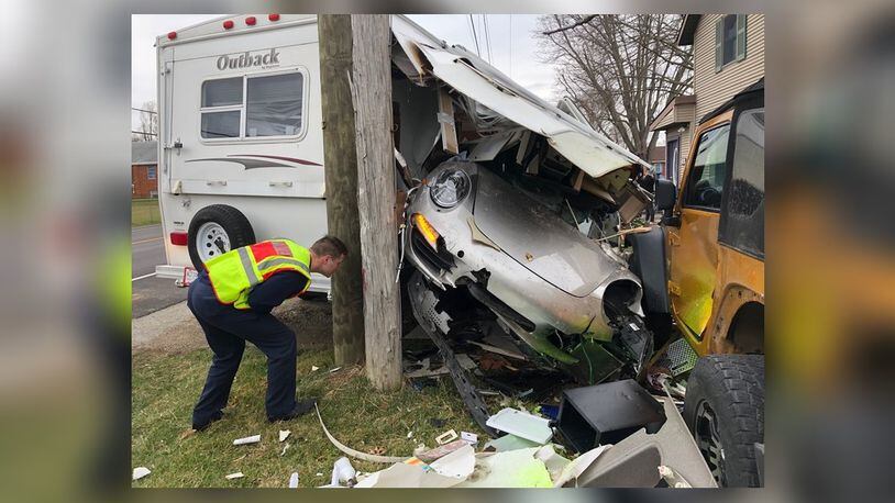 The driver of a silver Porsche 911 lost control on Springfield Xenia Road and crashed into two parked cars before smashing through a camper also parked along the road March 16, 2020, in Springfield Twp., Clark County. BILL LACKEY/STAFF