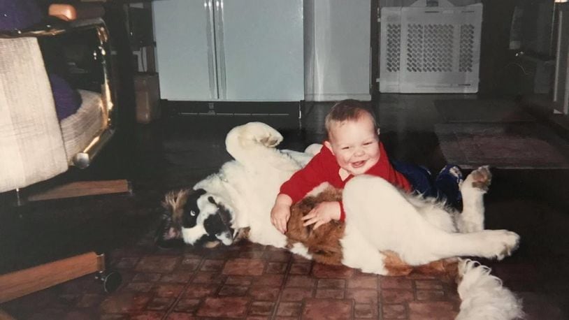 Two-year-old Wes Martin plays with his St. Bernard, Heidi. CONTRIBUTED