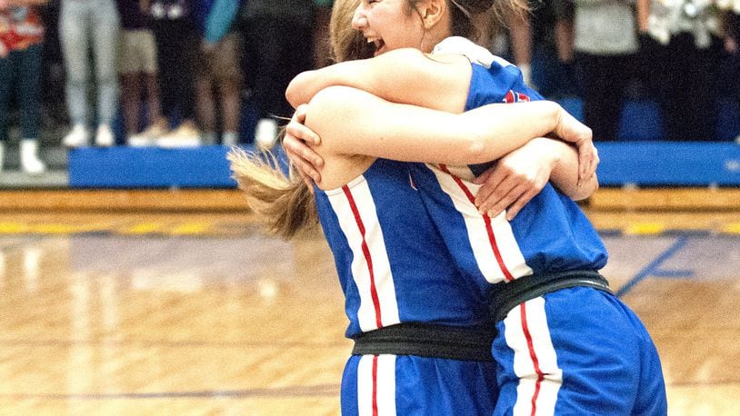 Carroll’s Ava Lickliter (right) and Jillian Roberts celebrate their 41-38 victory over Roger Bacon in the Division II regional final Friday night at Springfield High School. The Patriots will play in the state tournament for the second straight year. Jeff Gilbert/CONTRIBUTED