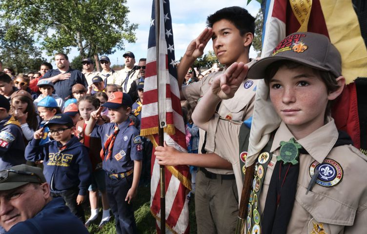 scouts place flags at veteran graves to honor memorial day