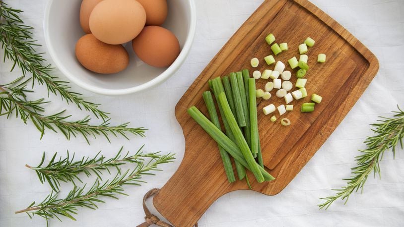 Some of the ingredients that go into a breakfast strata, made with eggs, cheese, bread, green onions, rosemary and other ingredients. Stratas make great use of leftover bread and other items. (Ellen M. Banner/The Seattle Times/TNS)