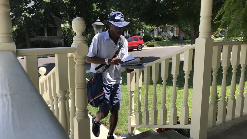 Dasean Johnson, 34, has been a mailman in Kettering for six years. He says that nighttime hydration is essential in preparation for his daily 4.5-mile route. STAFF/GRANT PEPPER