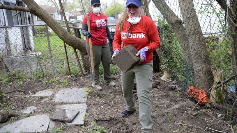 Nearly 500 Habitat for Humanities Rock the Block volunteers from within and outside Butler County made 21 exterior home repairs, painted 47 fire hydrants and worked to fill 11 32-cubic-foot Dumpsters on Saturday, April 13, 2019, in the Five Points area of the township. MICHAEL D. PITMAN/STAFF