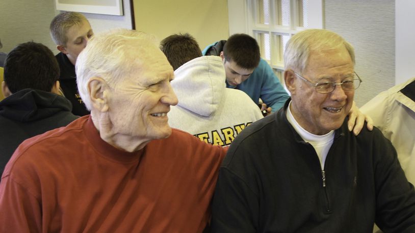 Chris Harris, right, and Bill Uhl smile during a breakfast with other Dayton teammates in 2013. CHRIS STEWART / STAFF