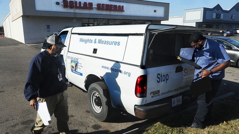 Montgomery County Auditor's Office chief inspector Joseph Harris, left, and inspector Brandon Ladson, right, prepares to inspect a local dollar store on Tuesday, Nov. 22, 2022. MARSHALL GORBY\STAFF