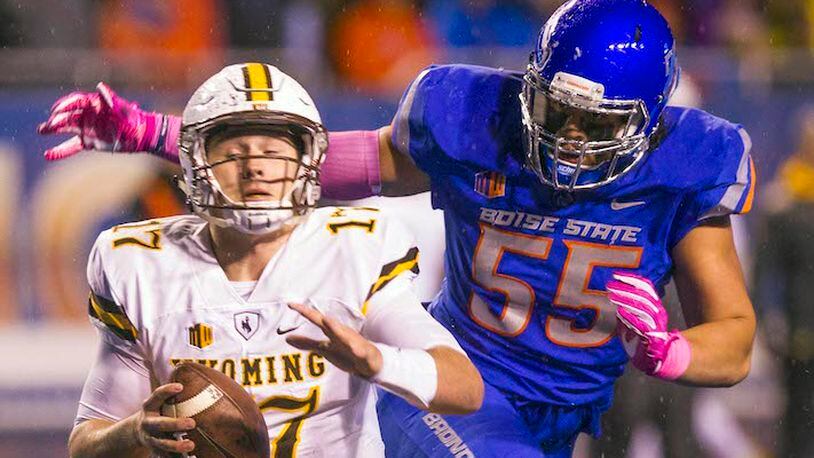 Wyoming quarterback Josh Allen (17) evades the grasp of Boise State defensive tackle David Moa (55) in the second half on Saturday, Oct. 21, 2017, at Albertsons Stadium in Boise, Idaho. (Darin Oswald/Idaho Statesman/TNS)