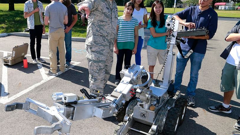 Clark County high school students participating in the Johns Hopkins Engineering Innovation Program at Clark State Community College got the chance to control the robot used by the Wright Patterson Air Force Base EOD team or “bomb squad” Tuesday, July 19, 2016. Guiding the students with the robot is StSgt. Nicholas Scheer. The Dayton Police Department’s bomb squad was also on hand demonstrating their robots for the students. BILL LACKEY/STAFF