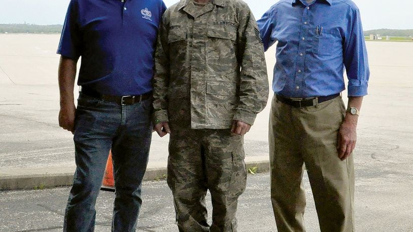 Charlie Hampton (left) stands with his son, Tech. Sgt. Robert Hampton, and brother, David Hampton, by the Wright-Patterson Air Force Base flightline where each of them served as a member of the 87th Aerial Port Squadron. (U.S. Air Force photo/2nd Lt. Rachel Ingram)