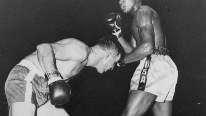 In this Oct. 29, 1960 photo, Cassius Clay, in white trunks is shown in his professional boxing debut, in Louisville’s Freedom Hall, against Tunney Hunsaker. The day before his star-studded funeral, members of Muhammad Ali’s Islamic faith will get their chance to say a traditional goodbye to the Champ. Bob Gunnell, a spokesman for Ali’s family, announced Monday that a Jenazah, a traditional Muslim funeral service, will be held at Freedom Hall at noon Thursday. (AP Photo/File)