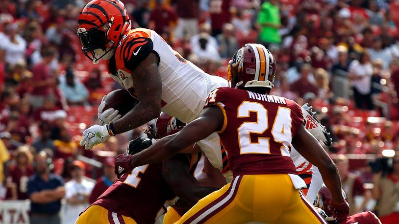 Cincinnati Bengals running back Jeremy Hill, left, dives into the end zone for a touchdown in front of Washington Redskins cornerback Josh Norman (24) in the first half of a preseason NFL football game, Sunday, Aug. 27, 2017, in Landover, Md. (AP Photo/Alex Brandon)
