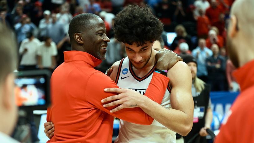 Dayton's Anthony Grant and Nate Santos hug after a victory against Nevada in the first round of the NCAA tournament on Thursday, March 21, 2024, at the Delta Center in Salt Lake City, Utah. David Jablonski/Staff