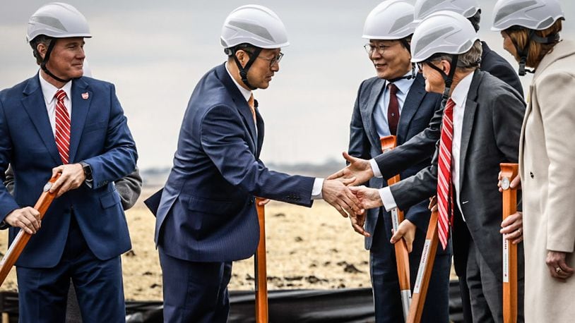 CEO of the new Honda/LG Energy joint venture, Robert Lee, left center,  shakes the hand of Ohio Gov. Mike DeWine after the groundbreaking of the new EV battery plant near Jeffersonville Feb. 28, 2023. JIM NOELKER/STAFF