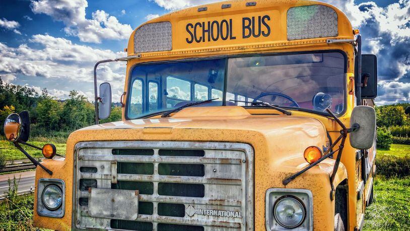 An Iowa woman was arrested after police said she narrowly missed hitting students exiting a bus at an elementary school.