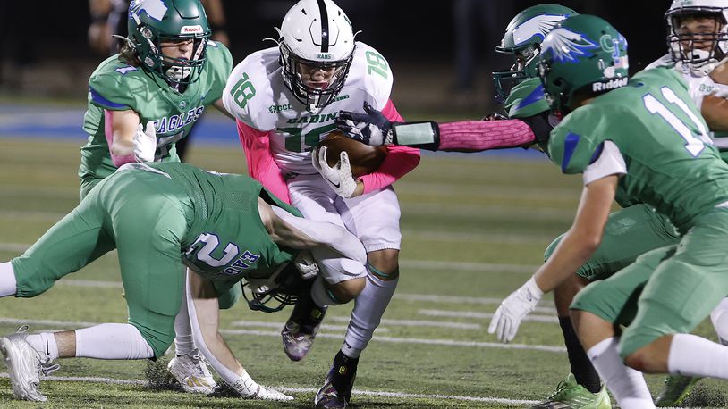 Badin's James Brink is tackled by a pack of CJ defenders. BILL LACKEY/STAFF