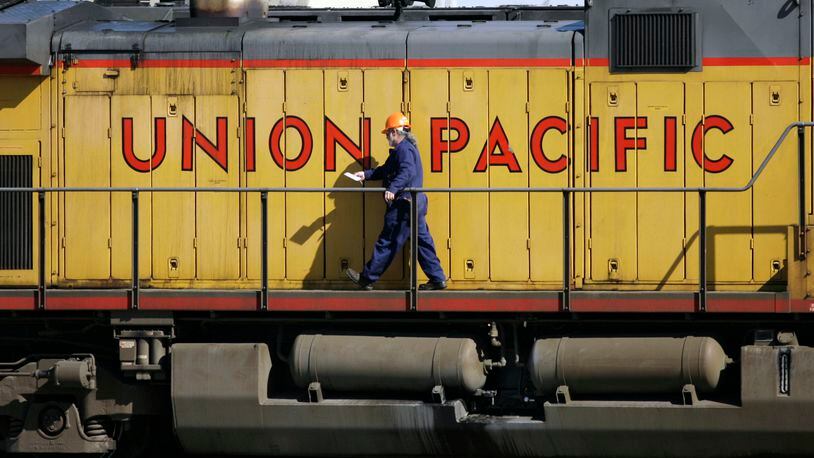 FILE - A maintenance worker walks past the company logo on the side of a locomotive in the Union Pacific Railroad fueling yard in north Denver, Oct. 18, 2006. Federal regulators say Union Pacific managers undermined their efforts to assess safety at the railroad in the wake of several high-profile derailments across the industry by coaching employees on how to respond and suggesting they might be disciplined. (AP Photo/David Zalubowski, File)