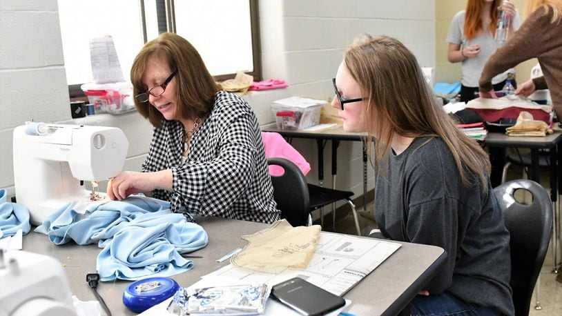 Teacher Lisa Colebaugh, left, works with a student in the Tippecanoe High School fashion design class. Students work with Colebaugh and co-instructor Alexis Gentry on the design and bringing to life of a sewing project.