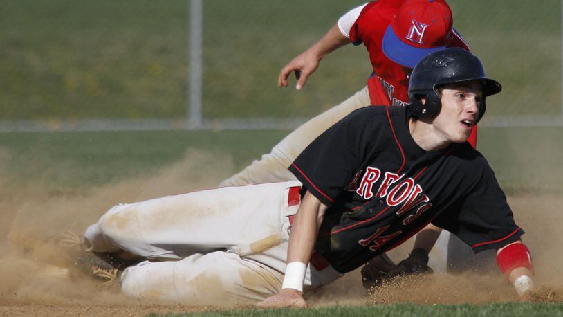 Tony Evans (14) of Tecumseh slides in to second base while defended by Justin Philpot (3) of Northwestern during Wednesday’s baseball game at Tecumseh on March 28, 2012. Photo by Barbara J. Perenic