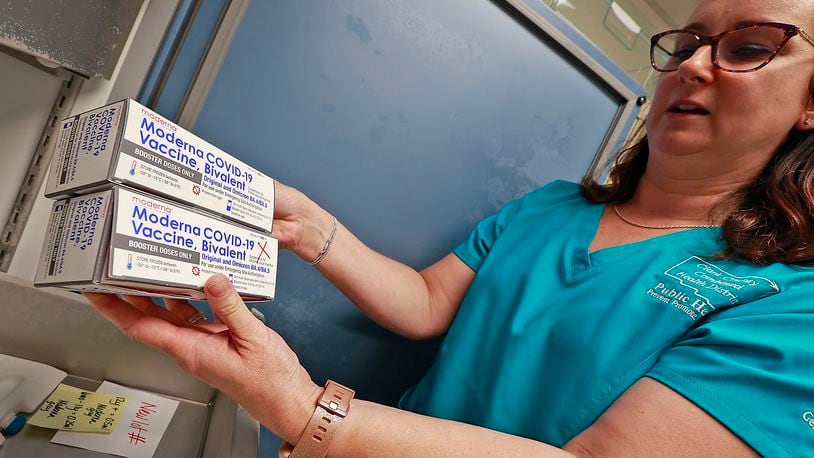 Kristen Earley, a nurse at the Clark County Combined Health District, shows some of the district's COVID vaccine as she sorts through the freezer Wednesday, June 21, 2023. BILL LACKEY/STAFF