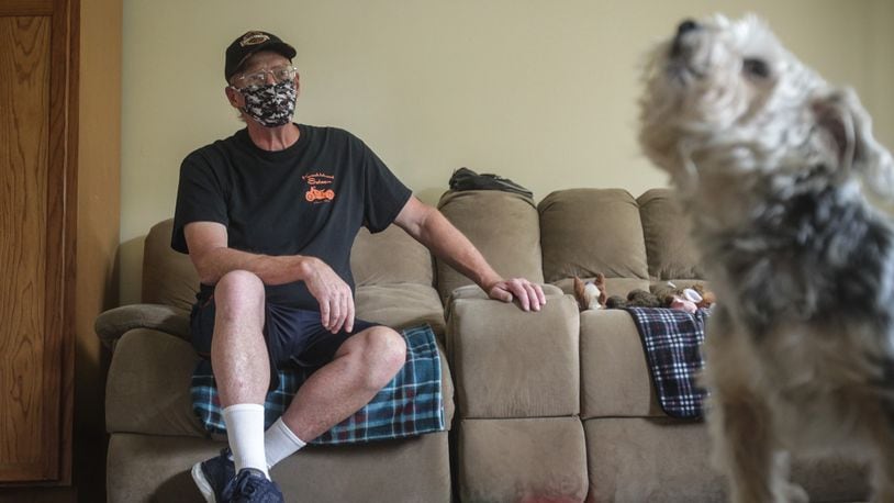 Michael Russell and his dog Rascal relax in their Dayton apartment Tuesday August 11, 2020. Michael Russell, an Air Force veteran received food vouchers and rental assistance through the Montgomery County Veterans Service Commission to help him through the pandemic. JIM NOELKER/STAFF