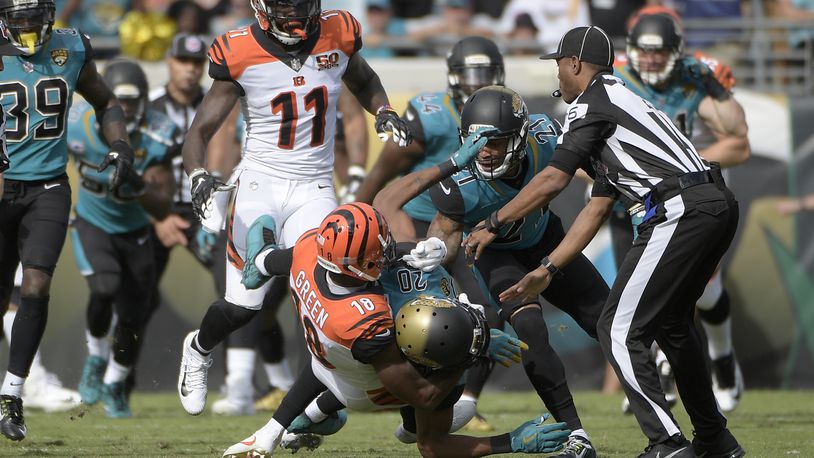 Cincinnati Bengals wide receiver A.J. Green (18) takes down Jacksonville Jaguars cornerback Jalen Ramsey (20) during a fight in the first half of an NFL football game Sunday, Nov. 5, 2017, in Jacksonville, Fla. (AP Photo/Phelan M. Ebenhack)